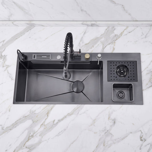 A matte black kitchen sink with a matching pull-down faucet, drain basket, and small storage compartment, shown installed on a white marble countertop.