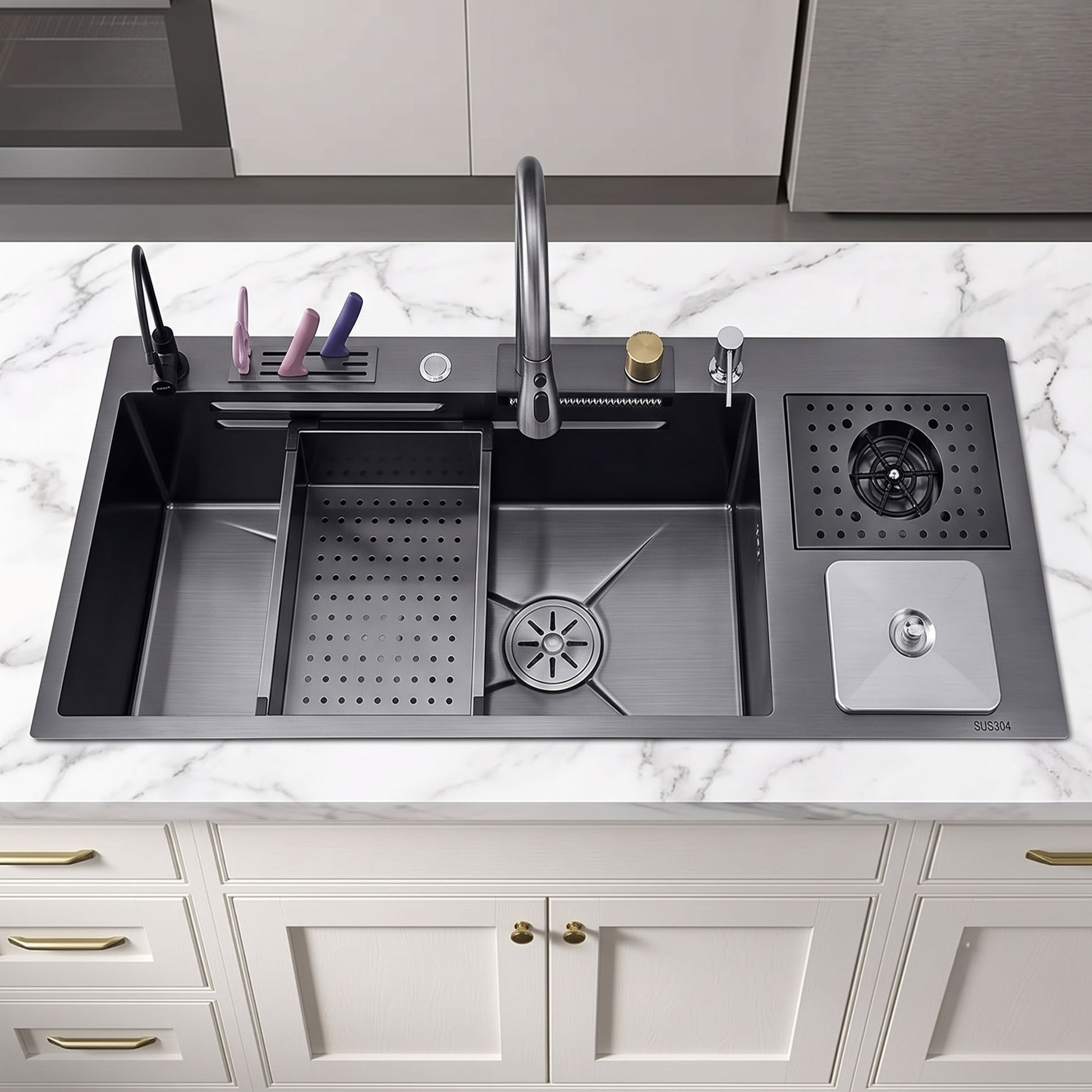 A dark gray double-bowl kitchen sink with a faucet, drain basket, and side storage tray, installed on a white marble countertop above white cabinets.