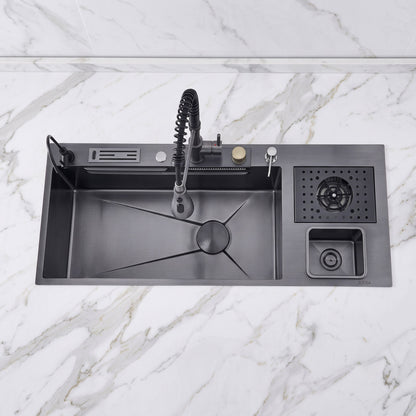 A matte black kitchen sink with a matching pull-down faucet, drain basket, and small storage compartment, shown installed on a white marble countertop.